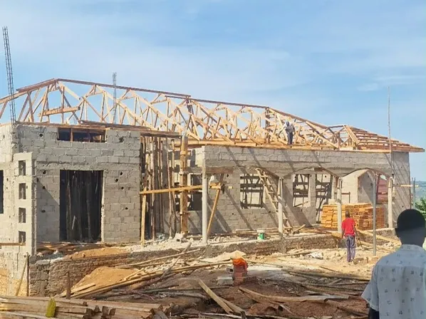 The new clinic under construction, with the timber roof trusses going up