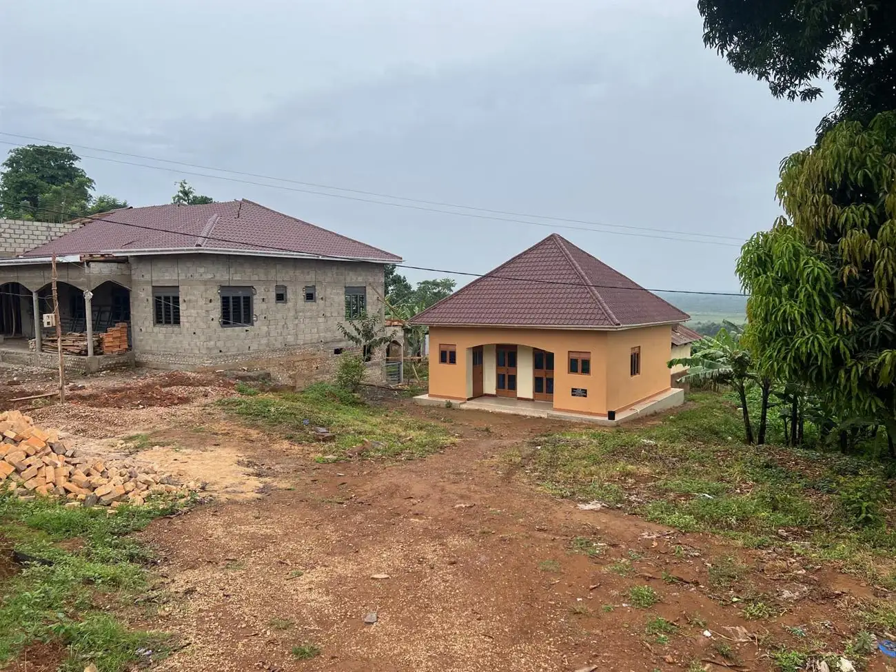 The new midwives’ house, finished and painted, beside the maternity clinic under construction